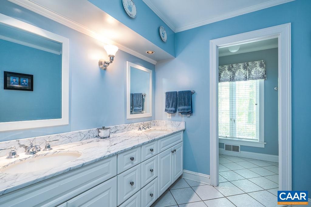960 Windsor Road Charlottesville, VA 22901 - Photo 29 of 51 a bathroom with a granite countertop double vanity sink a mirror and a