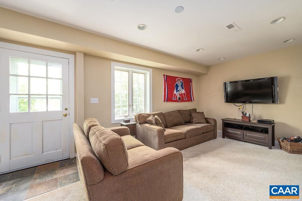 960 Windsor Road Charlottesville, VA 22901 - Photo 35 of 51 a living room with furniture and a flat screen tv