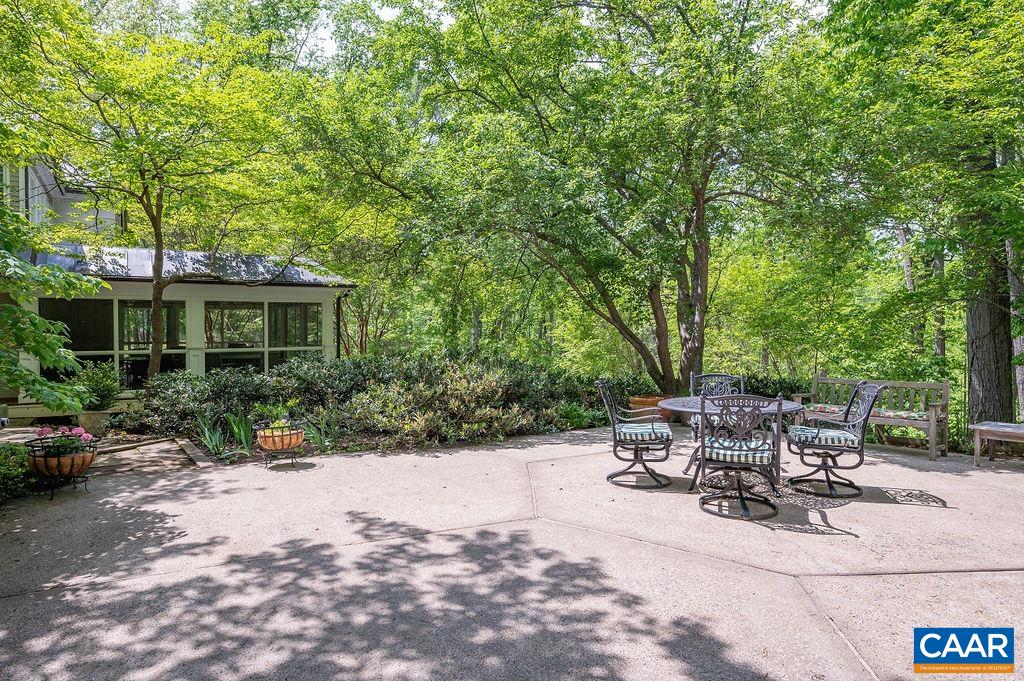 960 Windsor Road Charlottesville, VA 22901 - Photo 44 of 51 a view of a patio with table and chairs potted plants and large trees