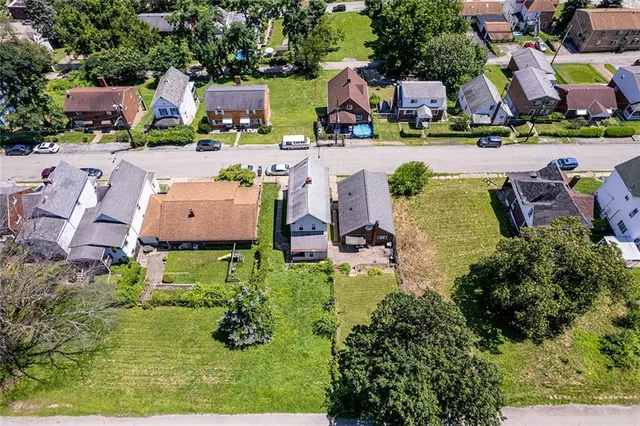an aerial view of a house with swimming pool garden and outdoor seating