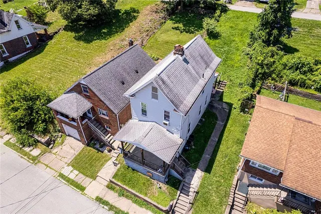 an aerial view of a house with a garden and swimming pool