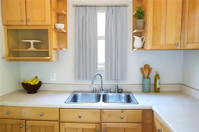 a kitchen with a sink and cabinets