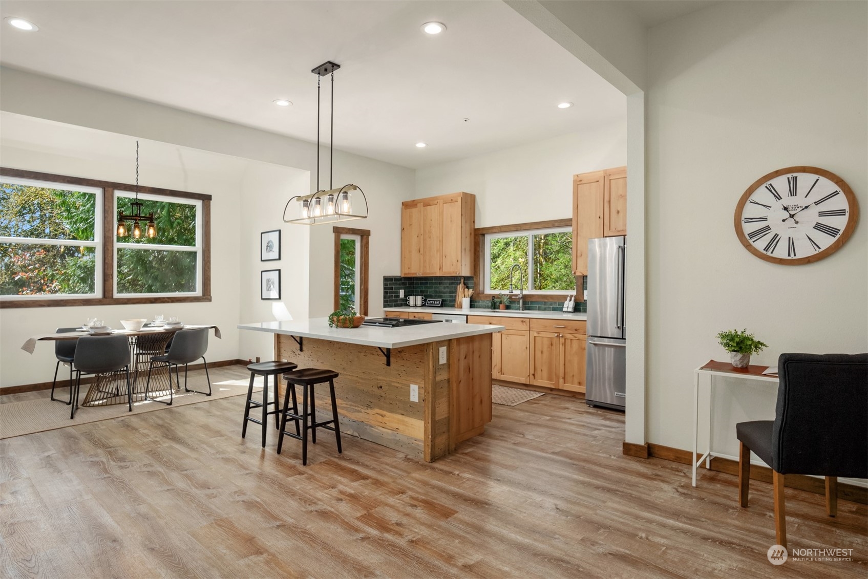 17548 Southeast 110th Street Renton, WA 98059 - Photo 6 of 37 a kitchen with sink cabinets and dining table
