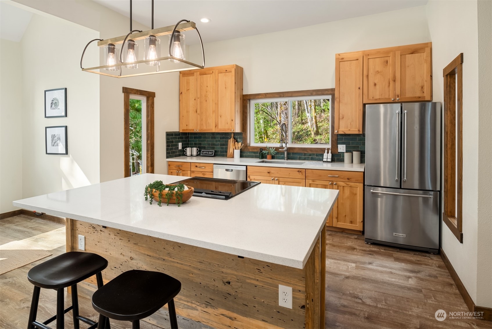 17548 Southeast 110th Street Renton, WA 98059 - Photo 8 of 37 a kitchen with stainless steel appliances a table chairs and refrigerator