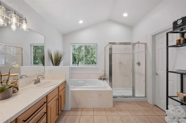 a bathroom with a tub sink and mirror