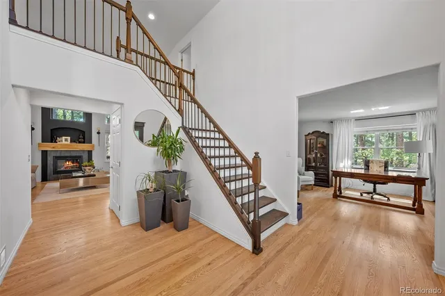a view of entryway and hall with wooden floor