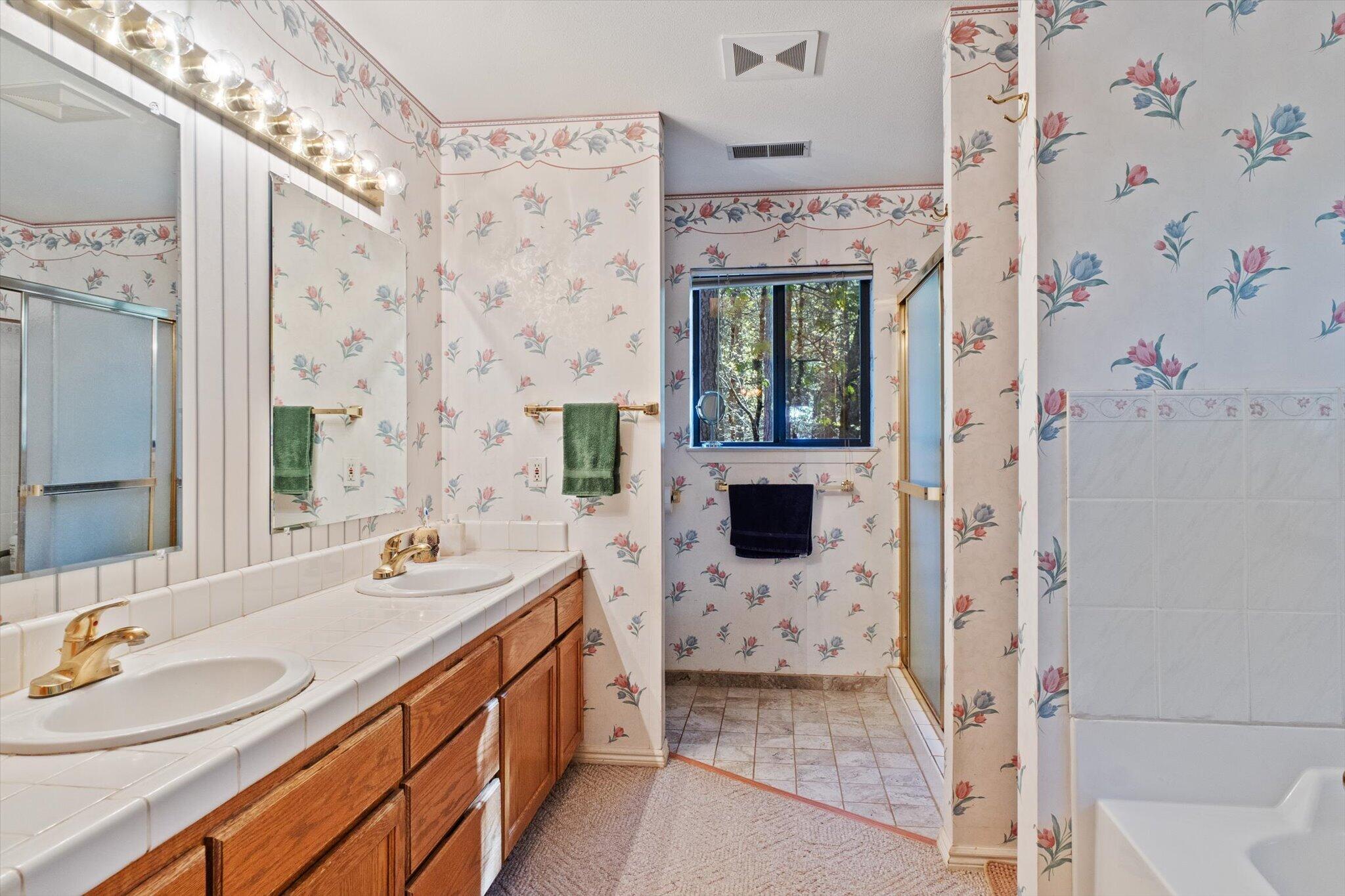 26997 Lookout Mountain Road Oak Run, CA 96069 - Photo 35 of 92 a spacious bathroom with a sink a mirror a shower and a mirror