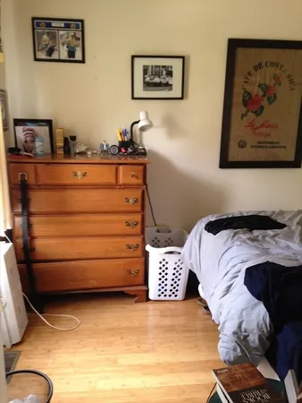 a bedroom with a bed and cupboard