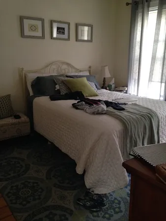 a bedroom with a bed and window