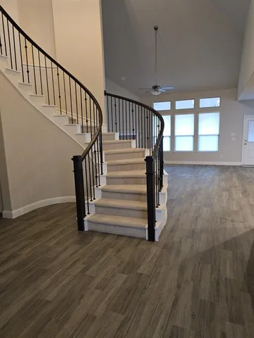 a view of entryway with wooden floor and stairs