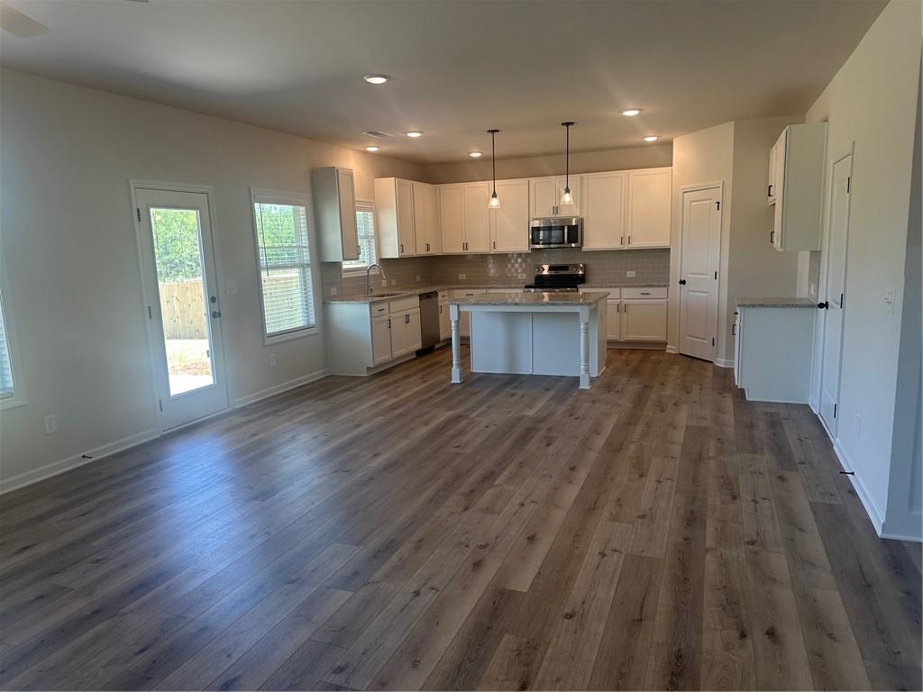 325 Rodeo Drive Auburn, GA 30011 - Photo 11 of 39 a view of kitchen with wooden floor and electronic appliances