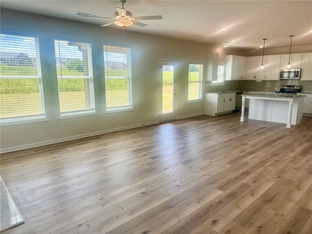 325 Rodeo Drive Auburn, GA 30011 - Photo 12 of 39 a view of kitchen with stove and wooden floor