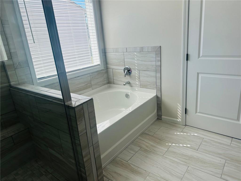 325 Rodeo Drive Auburn, GA 30011 - Photo 32 of 39 a bathroom with a bathtub and shower