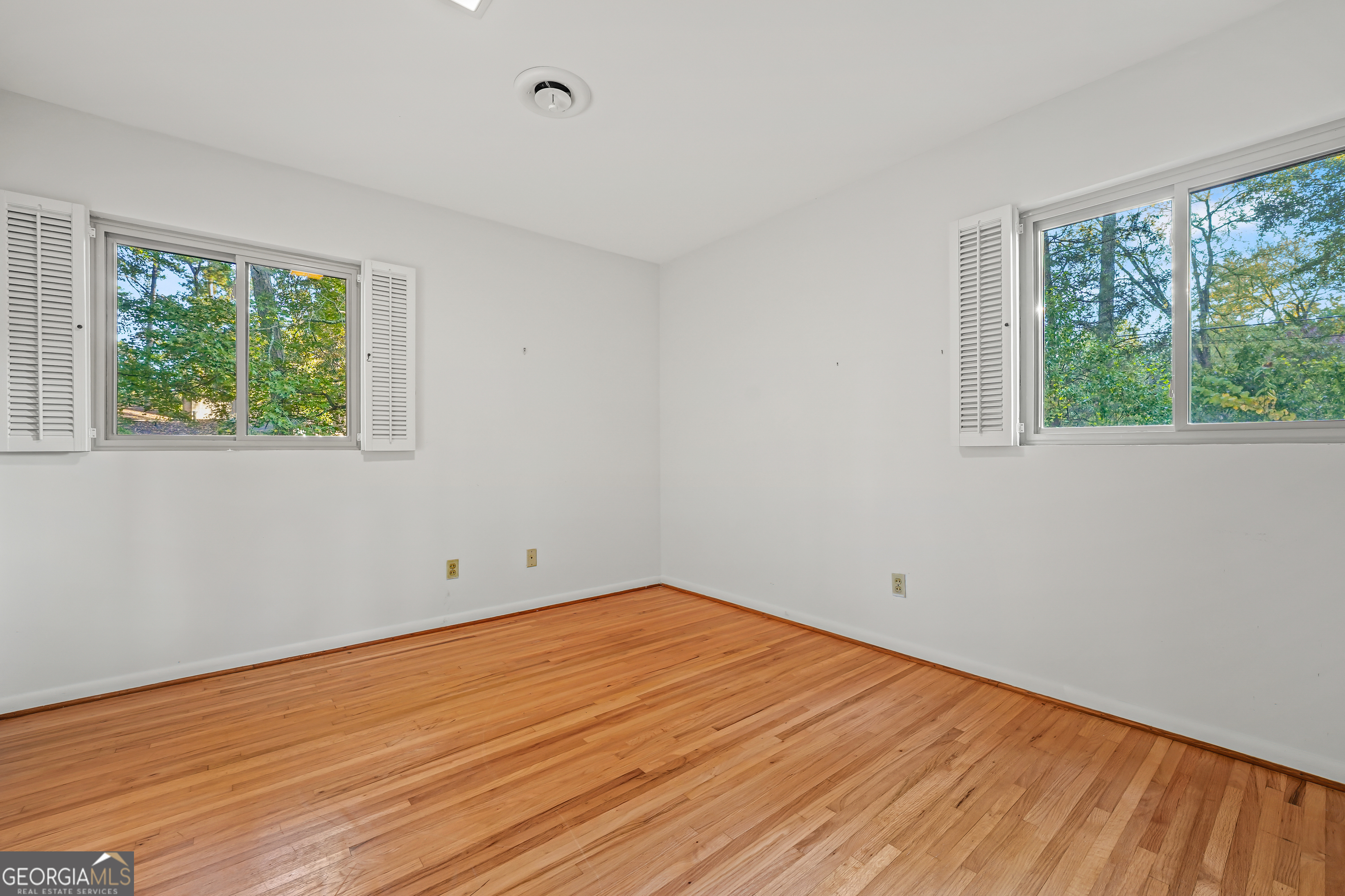 1784 Cedarwood Road Milledgeville, GA 31061 - Photo 20 of 30 a view of empty room with wooden floor and fan
