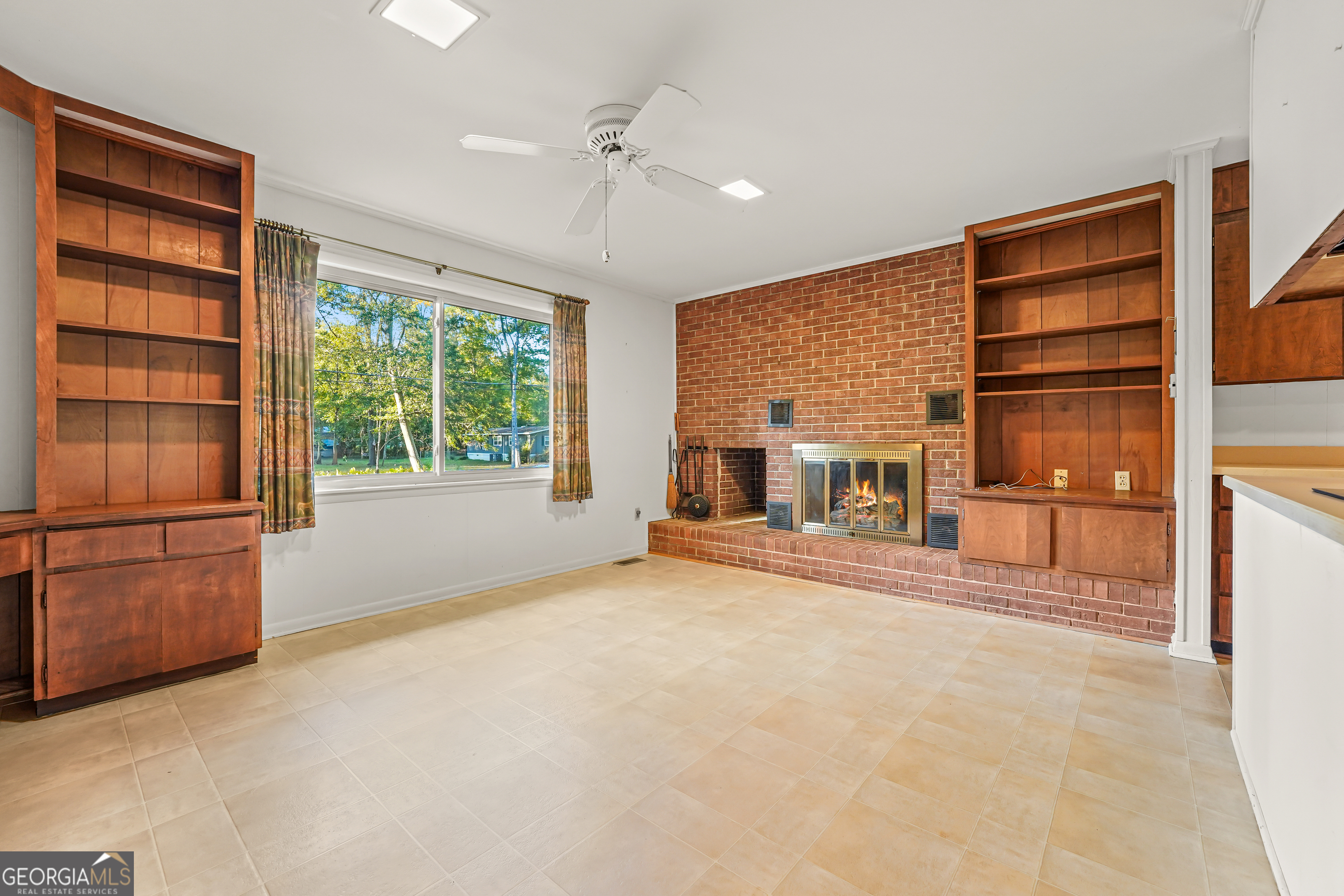 1784 Cedarwood Road Milledgeville, GA 31061 - Photo 7 of 30 an empty room with a fireplace and cabinet