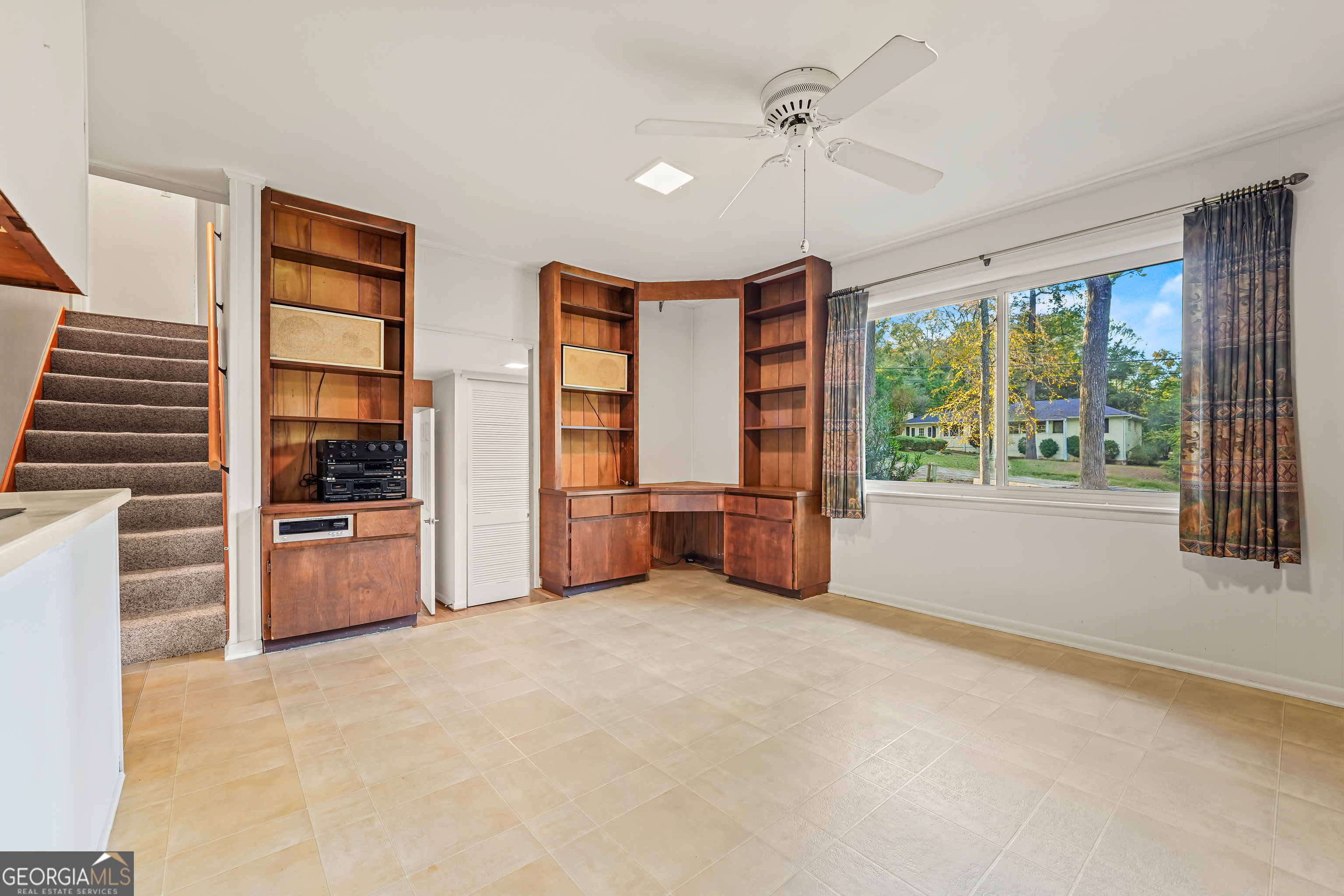 1784 Cedarwood Road Milledgeville, GA 31061 - Photo 8 of 30 a view of an empty room with a window and kitchen view