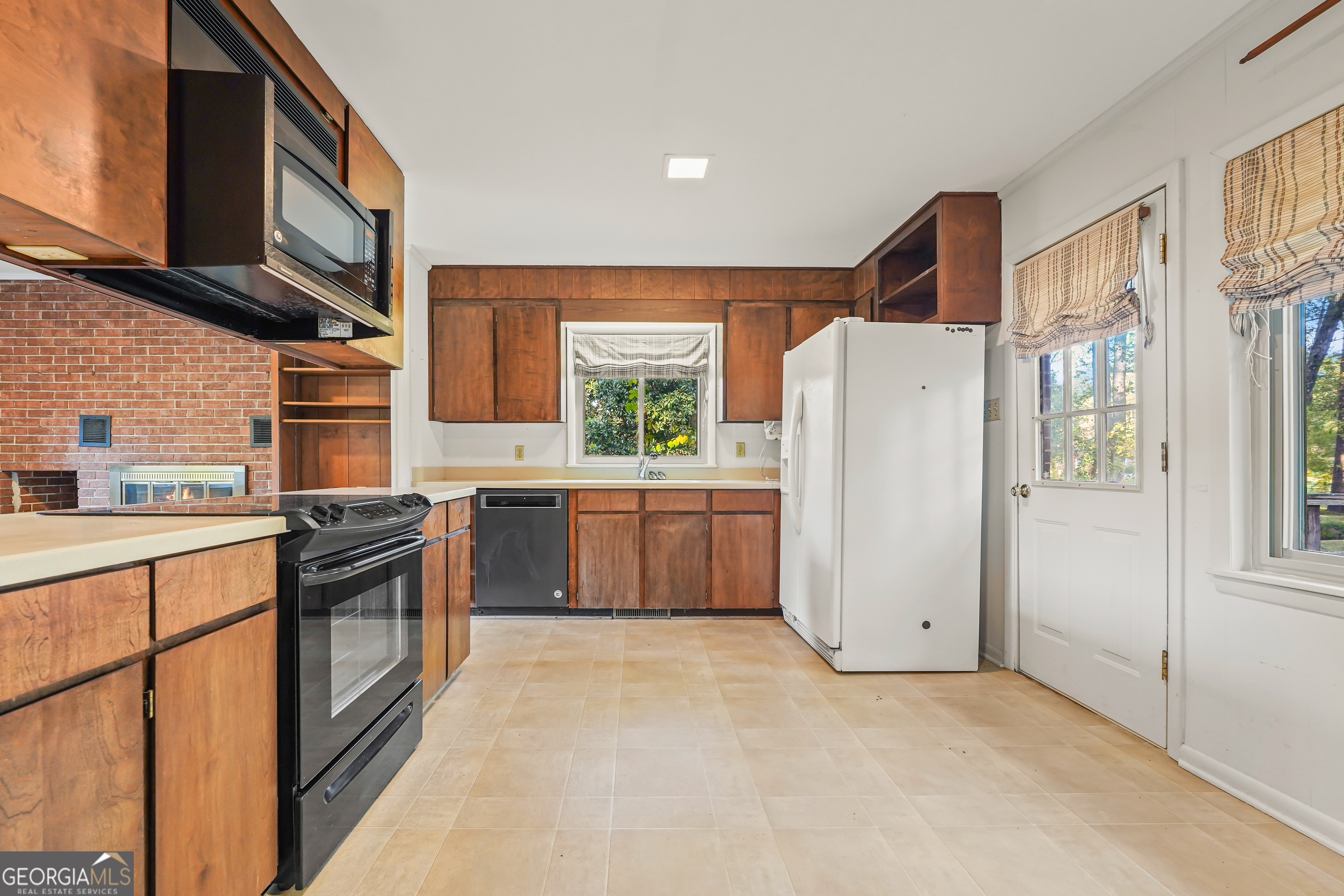 1784 Cedarwood Road Milledgeville, GA 31061 - Photo 10 of 30 a kitchen with stainless steel appliances a refrigerator sink and cabinets