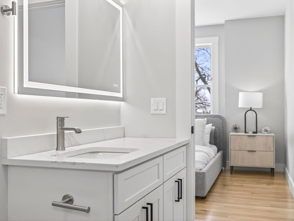 60 Stanley Street, Unit 203 Boston, MA 02125 - Photo 15 of 22 a bathroom with a sink and a mirror