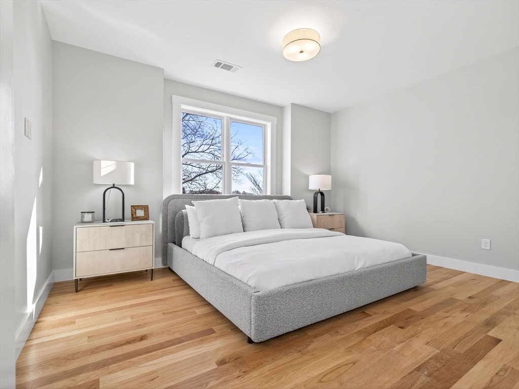 60 Stanley Street, Unit 203 Boston, MA 02125 - Photo 20 of 22 a bedroom with a large bed and a large window