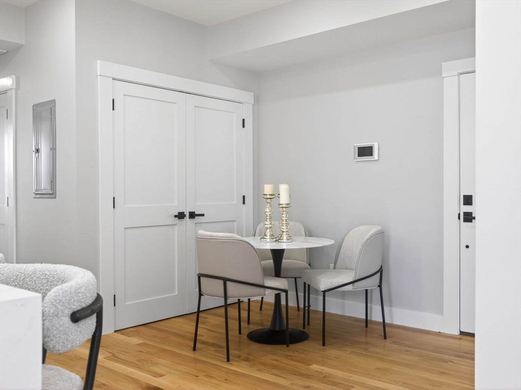 60 Stanley Street, Unit 203 Boston, MA 02125 - Photo 4 of 22 a view of a room with furniture and wooden floor