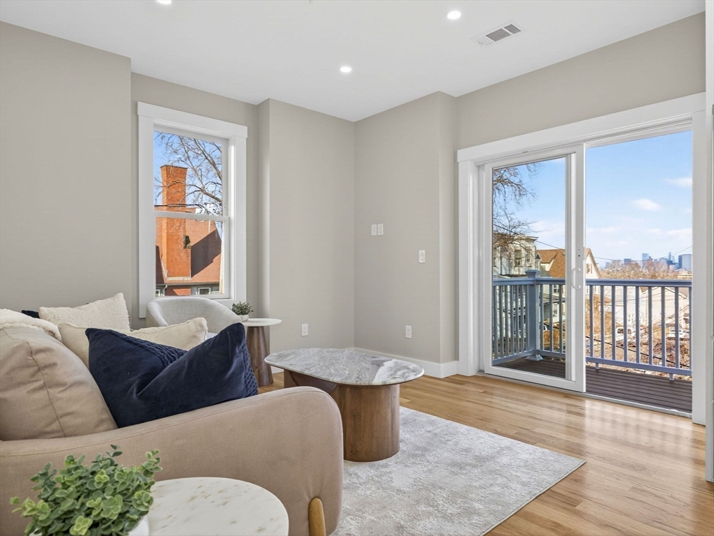 60 Stanley Street, Unit 203 Boston, MA 02125 - Photo 9 of 22 a living room with furniture and a window