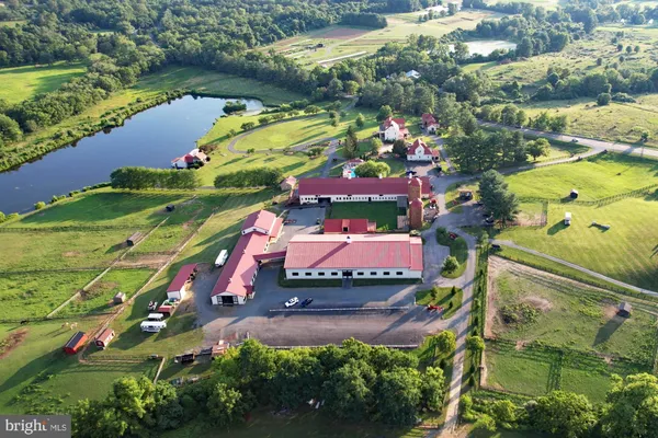 an aerial view of residential houses with outdoor space and lake view