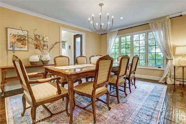 a kitchen with kitchen island granite countertop a table chairs sink and cabinets