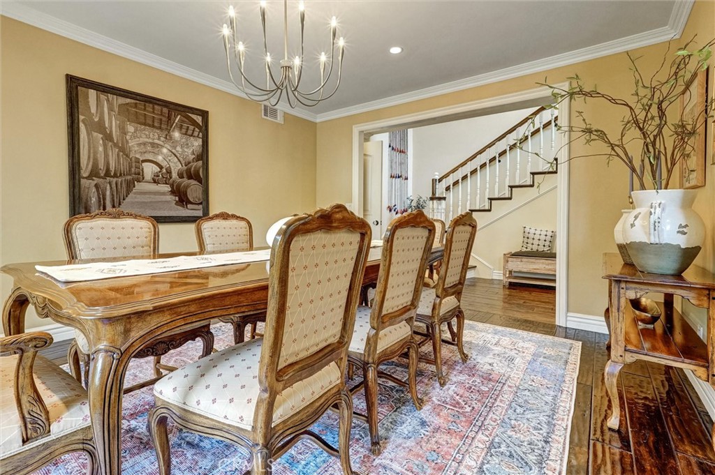 4751 Topeka Drive Tarzana, CA 91356 - Photo 14 of 65 a dining room with furniture a rug and wooden floor