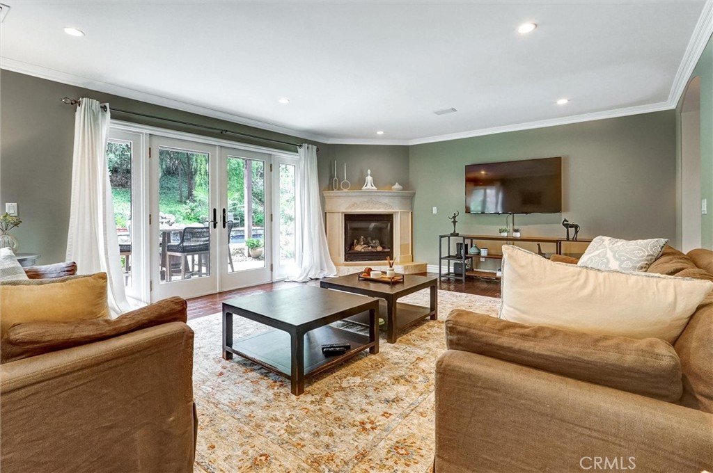 4751 Topeka Drive Tarzana, CA 91356 - Photo 21 of 65 a living room with furniture and a flat screen tv