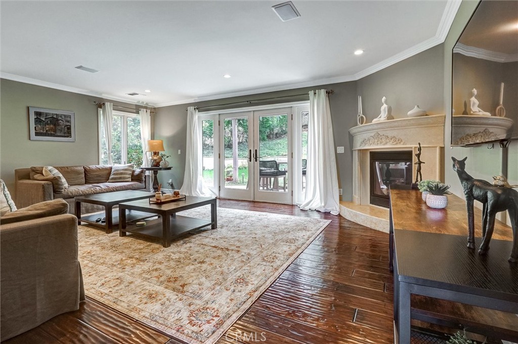 4751 Topeka Drive Tarzana, CA 91356 - Photo 22 of 65 a living room with furniture a fireplace and a table