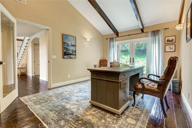 a view of a livingroom with wooden floor and furniture