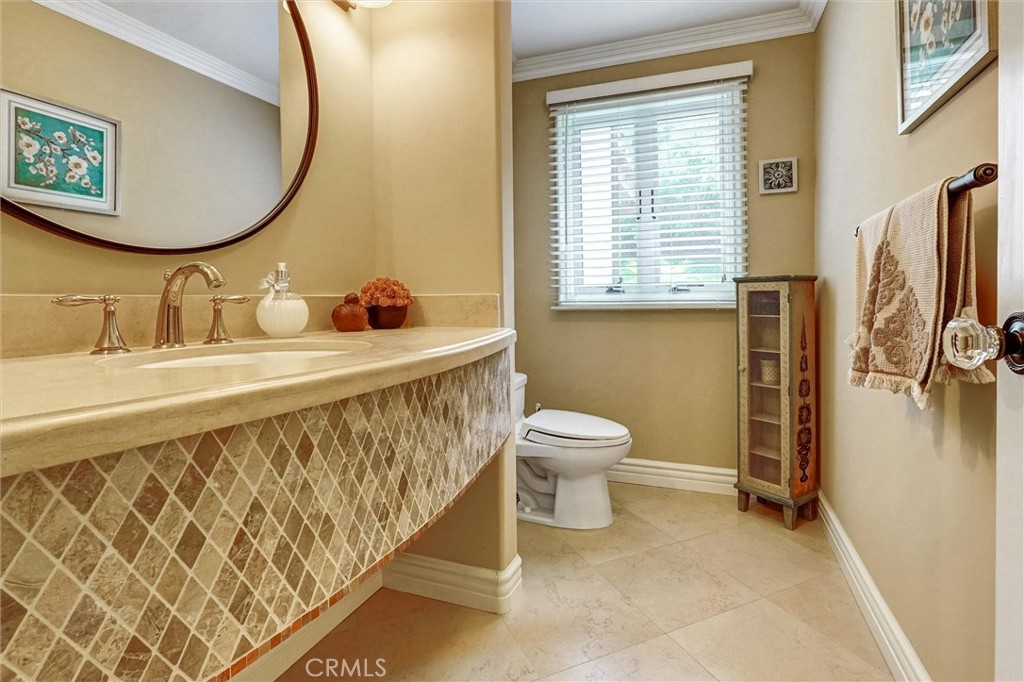 4751 Topeka Drive Tarzana, CA 91356 - Photo 26 of 65 a bathroom with a sink and a mirror