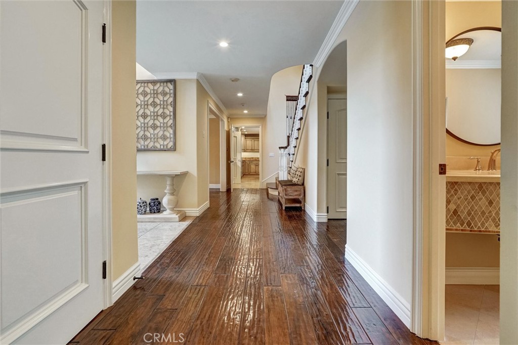 4751 Topeka Drive Tarzana, CA 91356 - Photo 27 of 65 a view of a hallway with wooden floor windows and a bathroom