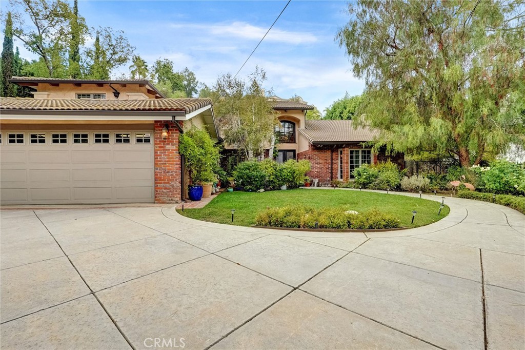 4751 Topeka Drive Tarzana, CA 91356 - Photo 3 of 65 a view of a white house with a yard and potted plants