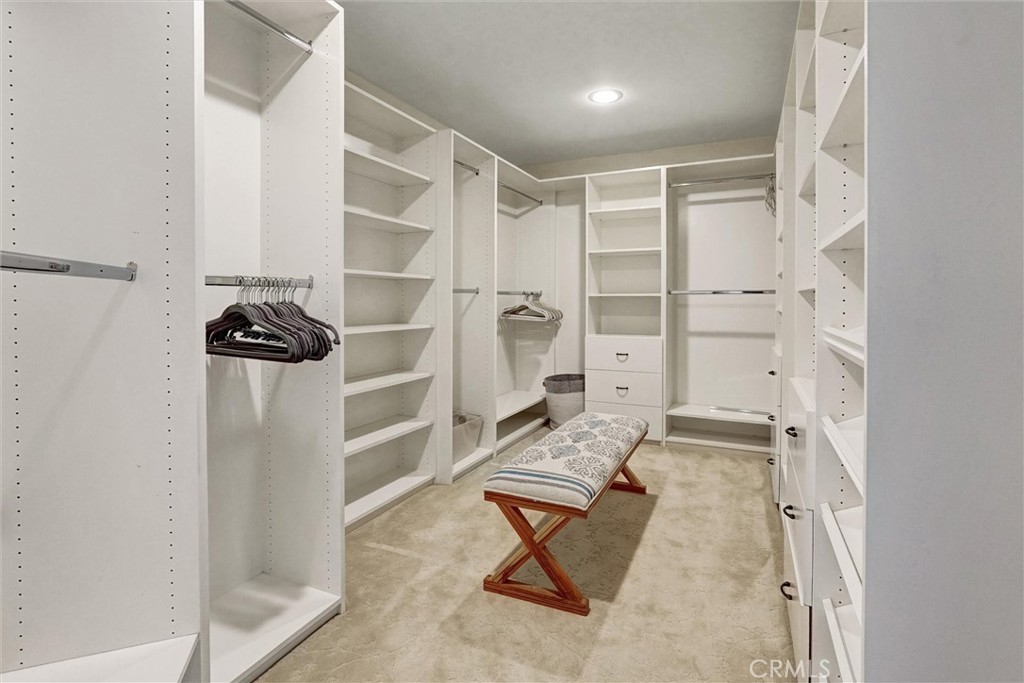 4751 Topeka Drive Tarzana, CA 91356 - Photo 34 of 65 a view of walk in closet with clothes and shoes