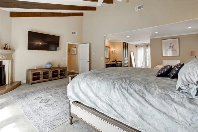 a spacious bedroom with a bed and a couch