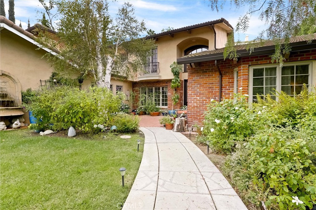 4751 Topeka Drive Tarzana, CA 91356 - Photo 4 of 65 a front view of a house with garden