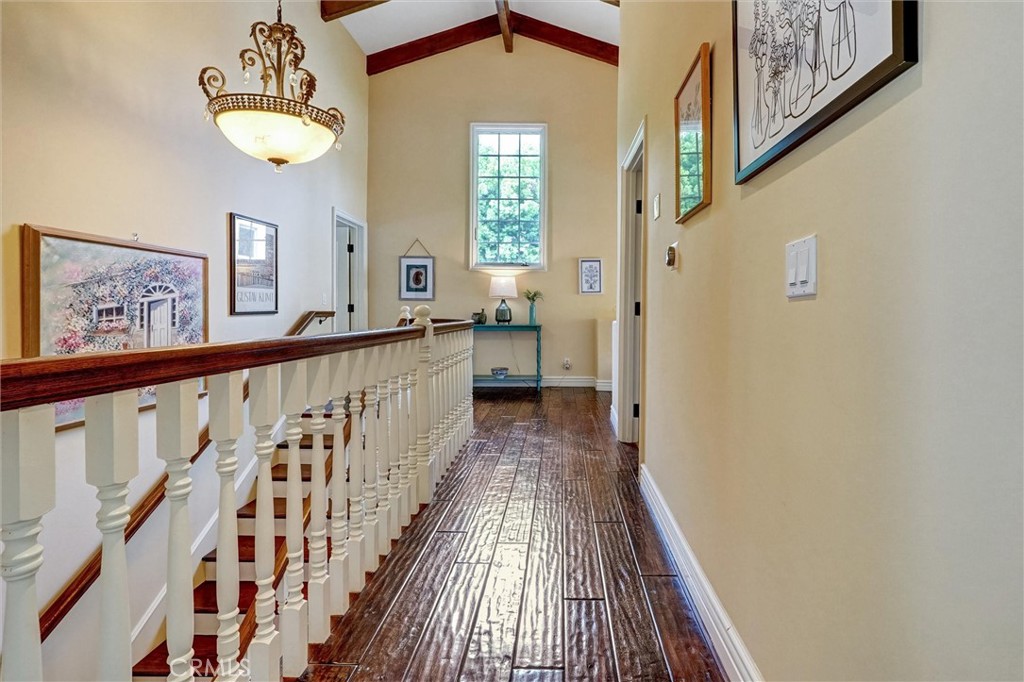 4751 Topeka Drive Tarzana, CA 91356 - Photo 41 of 65 a view of a hallway with wooden floor and staircase