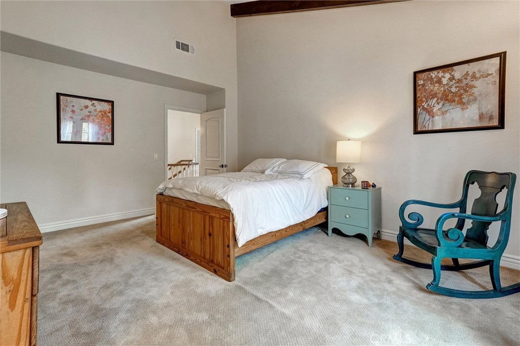 4751 Topeka Drive Tarzana, CA 91356 - Photo 42 of 65 a bedroom with a bed and a chair