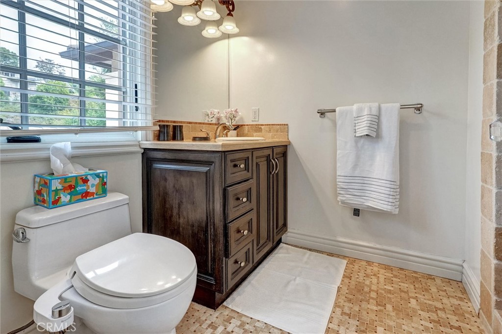 4751 Topeka Drive Tarzana, CA 91356 - Photo 45 of 65 a bathroom with a sink a toilet and a window