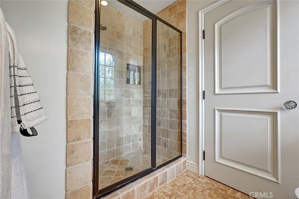 4751 Topeka Drive Tarzana, CA 91356 - Photo 46 of 65 a bathroom with a glass shower door