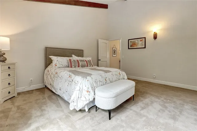 a view of a white house with a yard table and chairs
