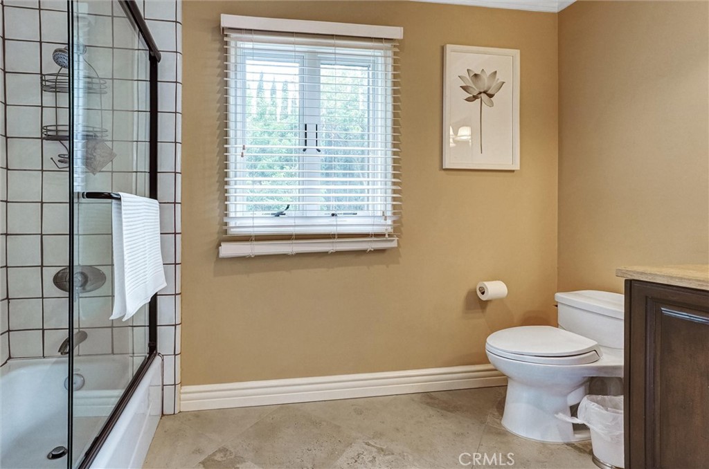 4751 Topeka Drive Tarzana, CA 91356 - Photo 49 of 65 a bathroom with a toilet and a shower