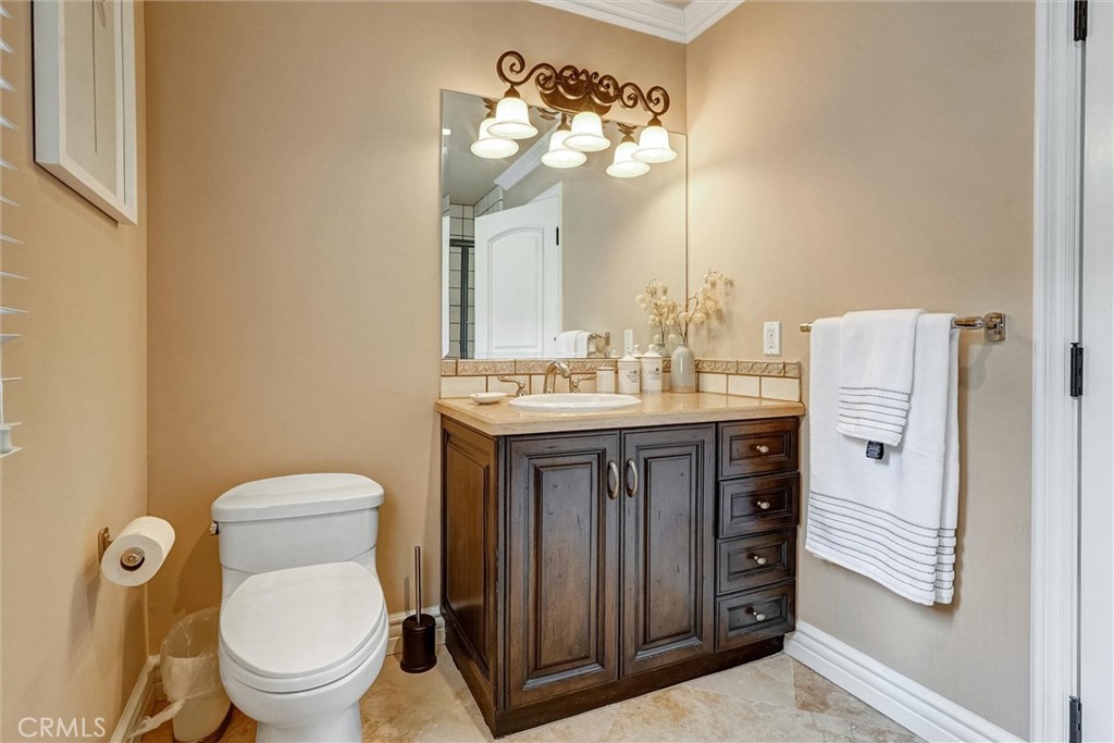 4751 Topeka Drive Tarzana, CA 91356 - Photo 50 of 65 a bathroom with a sink a toilet and a mirror