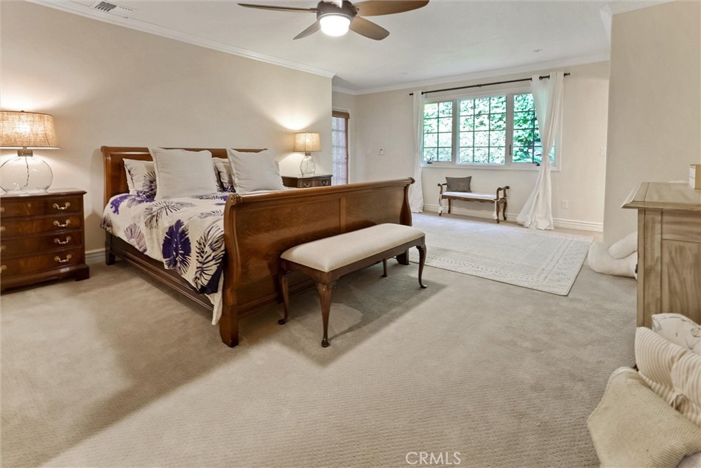 4751 Topeka Drive Tarzana, CA 91356 - Photo 52 of 65 a spacious bedroom with a bed and a couch