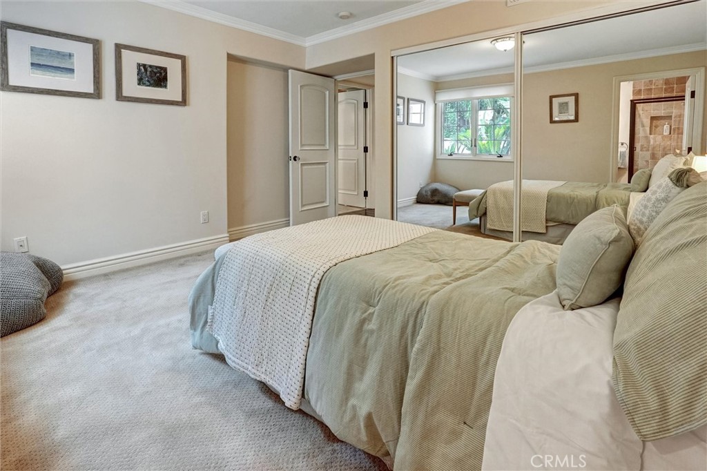 4751 Topeka Drive Tarzana, CA 91356 - Photo 54 of 65 a spacious bedroom with a bed and a window