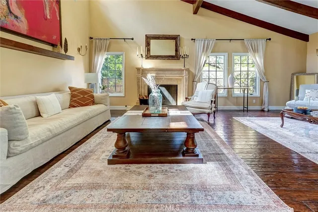 a living room with furniture a fireplace and a large window