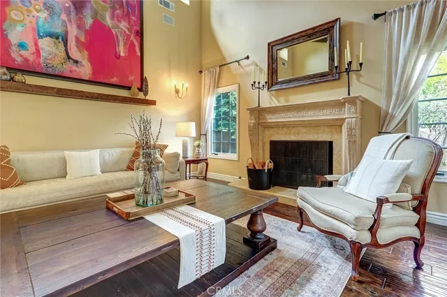 a living room with fireplace furniture and a large window