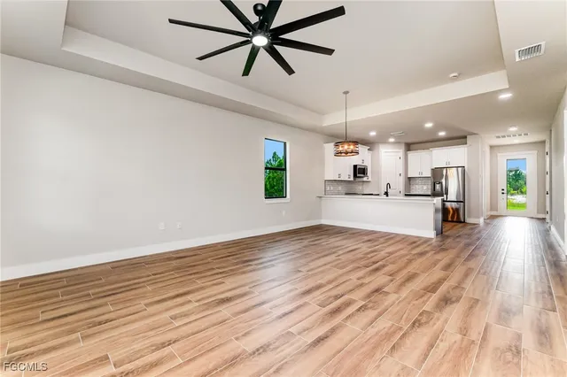 a view of a kitchen with a sink and wooden floor