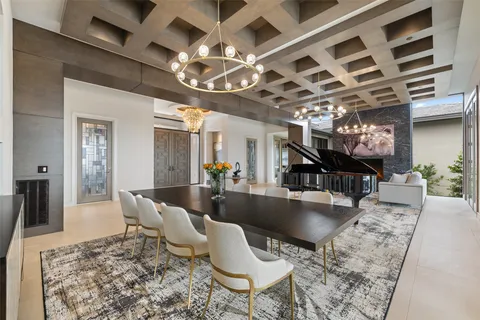 a living room with lots of furniture and kitchen view